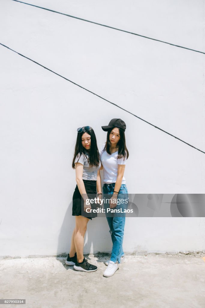 Young woman in front of white wall