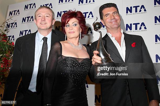 Members of the "The X Factor" Louis Walshe, Sharon Osbourne and Simon Cowell pose with the award for Most Popular Talent Show at the National...