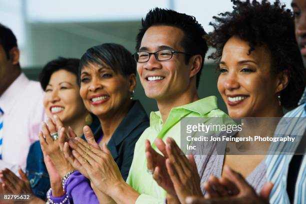 multi-ethnic business people clapping - business awards photos et images de collection