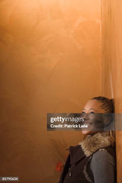 african woman looking up and smiling - patrick wall stock pictures, royalty-free photos & images