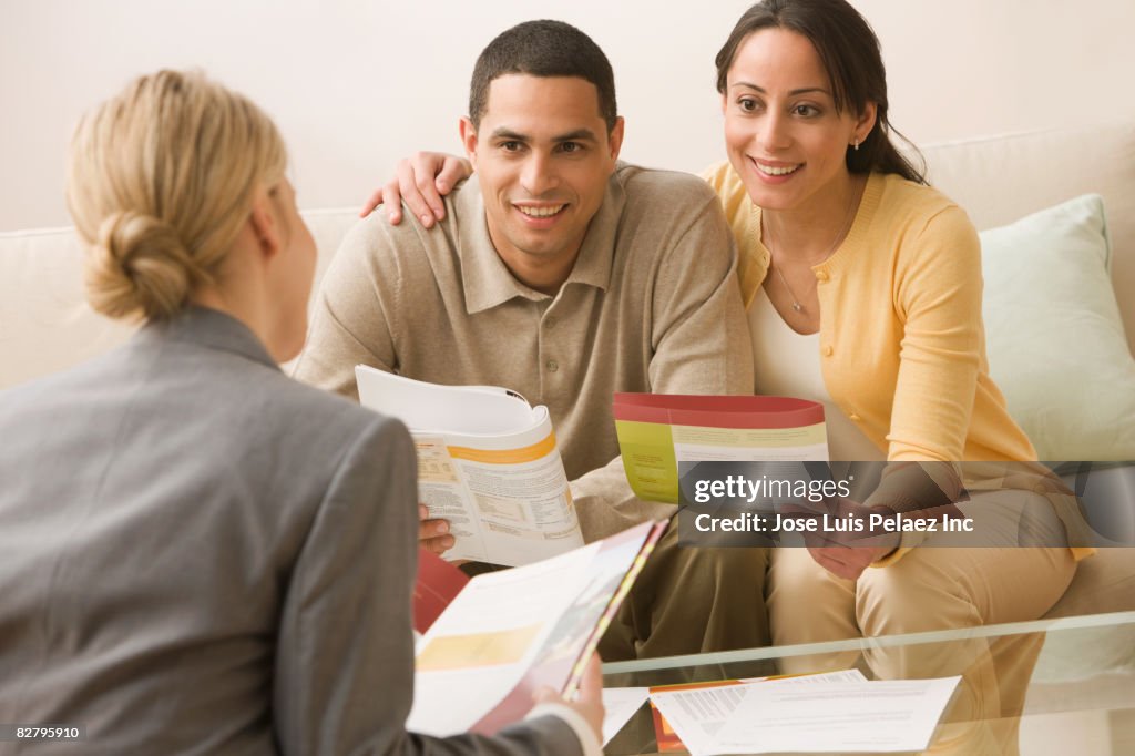 Hispanic couple receiving financial consultation