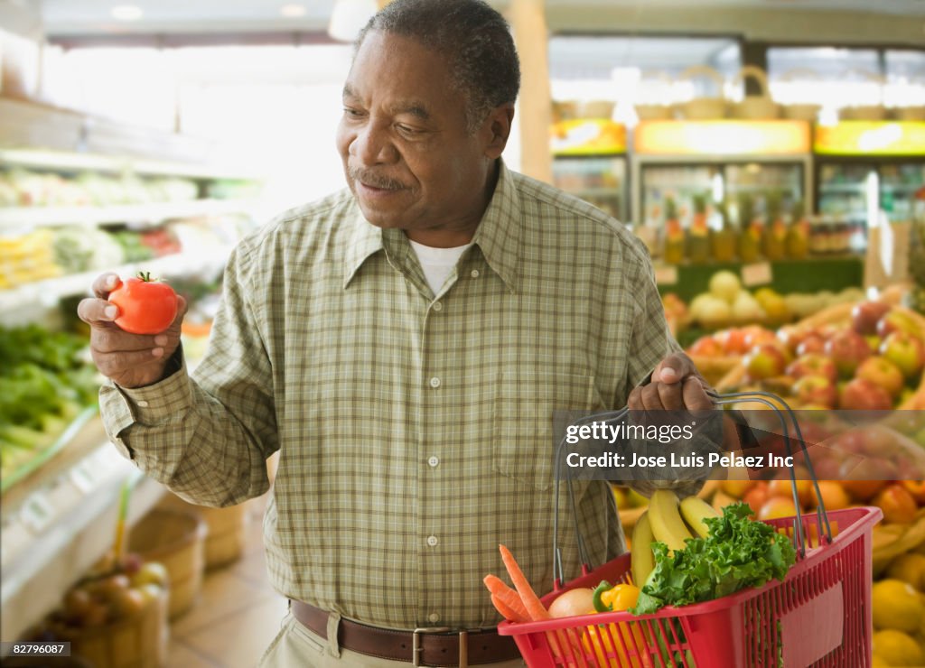 African man shopping for produce in grocery store