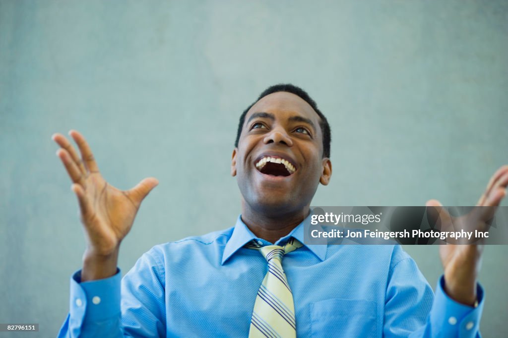 African businessman smiling and gesturing