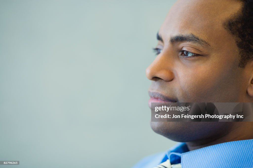 Close up of African businessman looking pensive