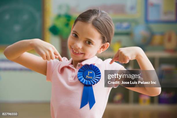 hispanic girl wearing first place ribbon - awards inside stock pictures, royalty-free photos & images