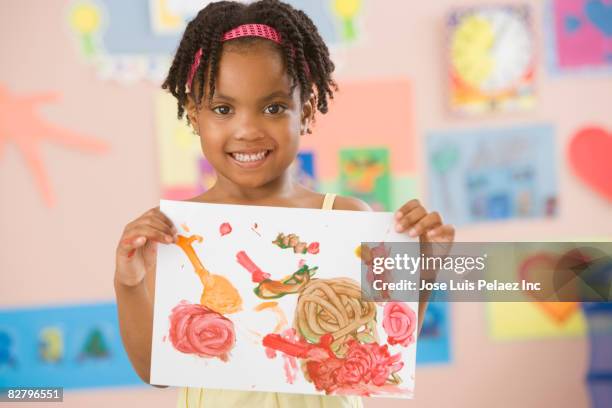 african school girl holding painting in classroom - 4 girls finger painting stock pictures, royalty-free photos & images