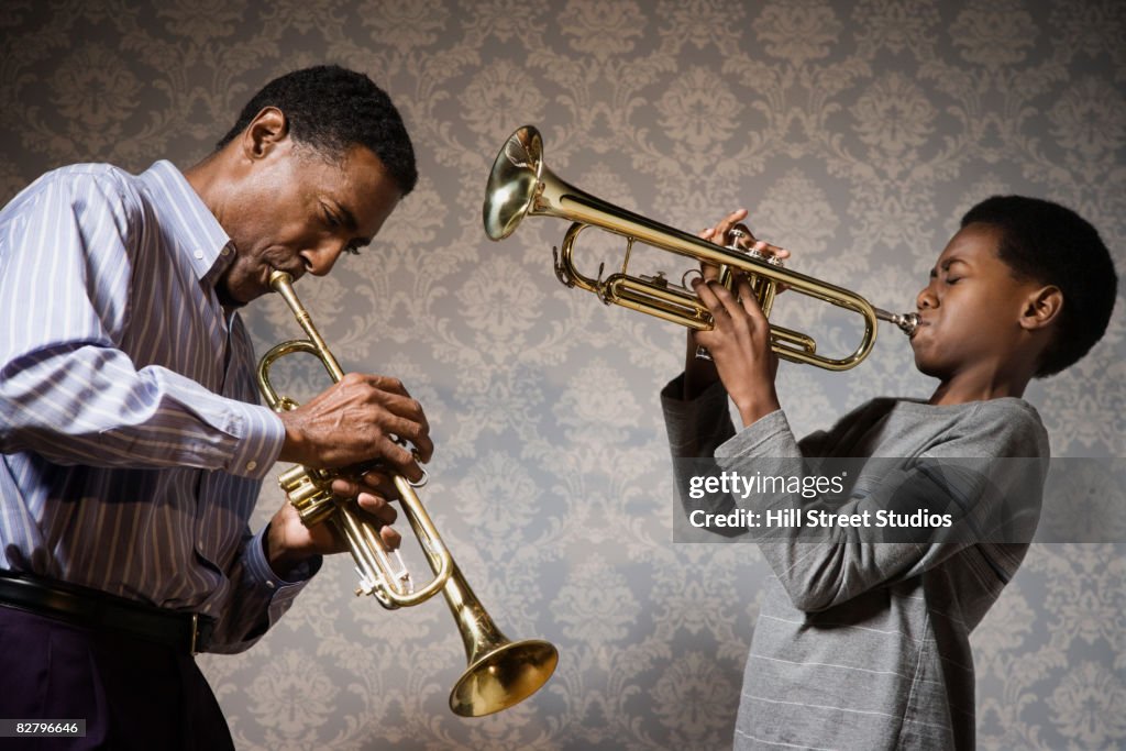 African man and boy playing trumpets