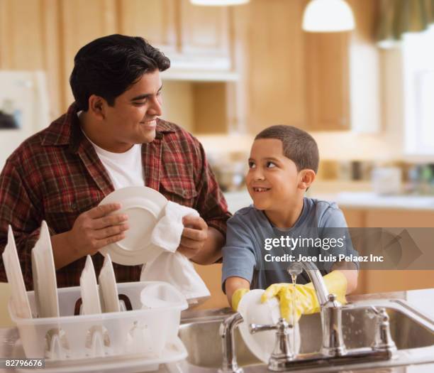 hispanic father and son washing dishes - wash the dishes stock pictures, royalty-free photos & images