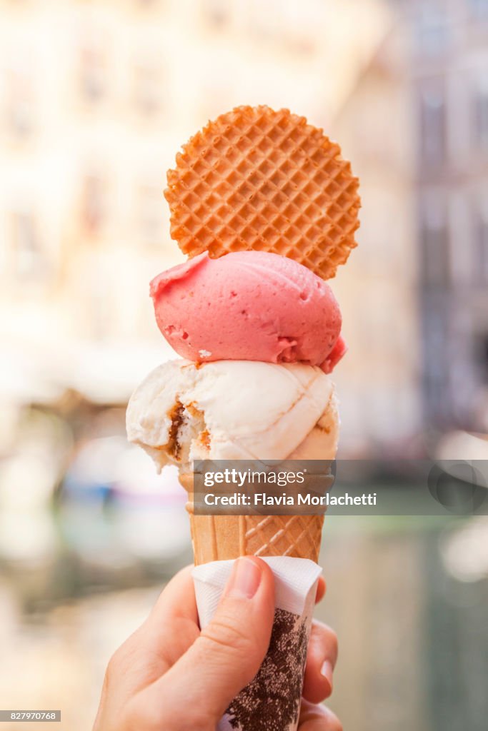 Hand holding 'Gelato' in Venice