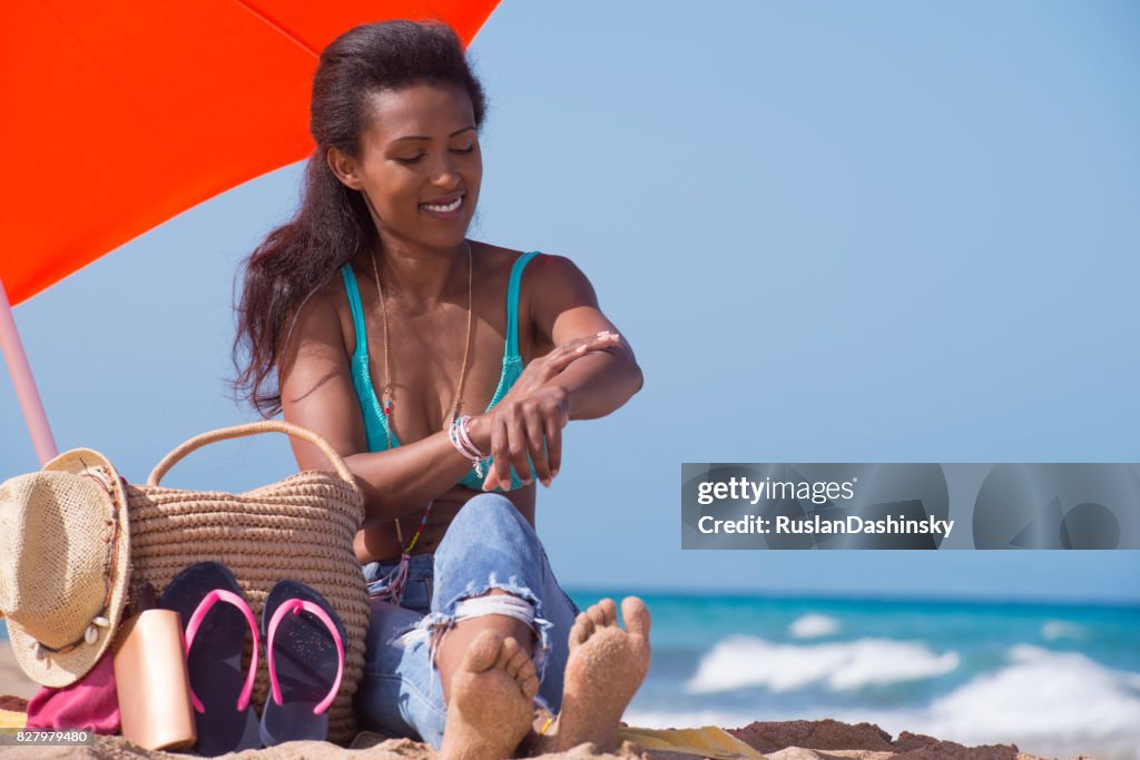 Woman skin protection on the beach.