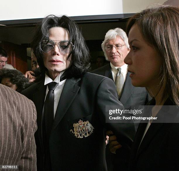 Michael Jackson exits the Santa Barbara County Superior Court in Santa Maria, Calif., with his attorneys Thomas Mesereau Jr. And Susan Yu, right...