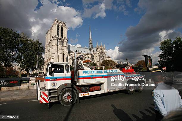 Police truck stands watch as Catholics wait for Pope Benedict XVI arrival at the iconic Notre Dame cathedral during an evening service, on September...