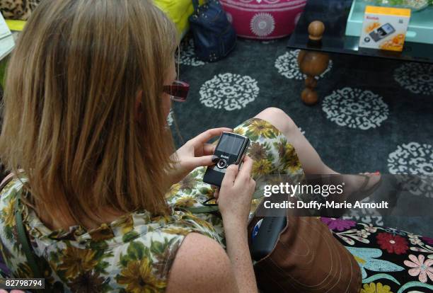 Amy Packer from S Magazine UK looks at the Kodak Zi6 Camera while attending Microsoft's Great American Style at Robert Verdi's Luxe Laboratory on...