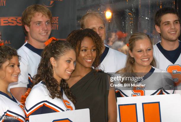 Nicole Behaire, center, poses with members of Syracuse University's Cheer leading team during the world premiere of "The Express" at the Landmark...