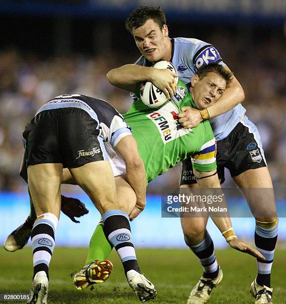 Scott Logan of the Raiders is tackled during the second NRL qualifying final match between the Cronulla Sharks and the Canberra Raiders at Toyota...