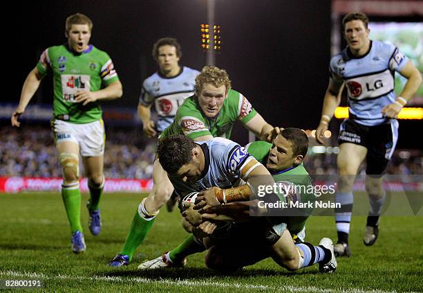 Brett Seymour of the Sharks heads for the try line during the second NRL qualifying final match between the Cronulla Sharks and the Canberra Raiders...