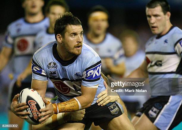 Brett Seymour of the Sharks looks to offload during the second NRL qualifying final match between the Cronulla Sharks and the Canberra Raiders at...