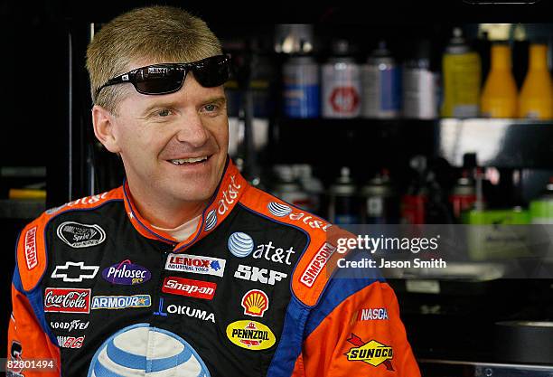 Jeff Burton, driver of the AT&T Mobility Chevrolet, stands in the garage area, during practice for the NASCAR Sprint Cup Series Sylvania 300 at New...