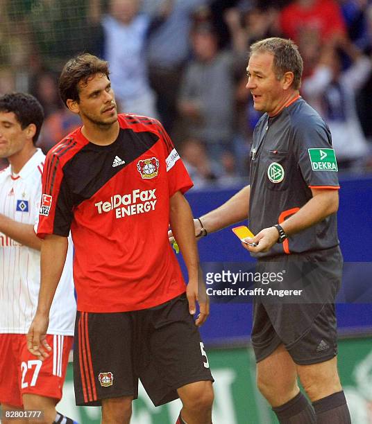 Manuel Friederich of Leverkusen receives the red card from referee Helmut Fleischer during the Bundesliga match between Hamburger SV and Bayer...