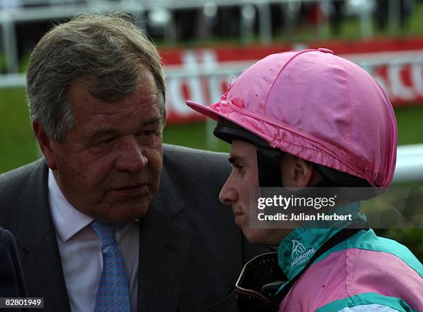 Sir Michael Stoute talks with stable jockey Ryan Moore after Doctor Freemantle finished 8th in The Ladbrokes St. Leger Stakes Race run at Doncaster...