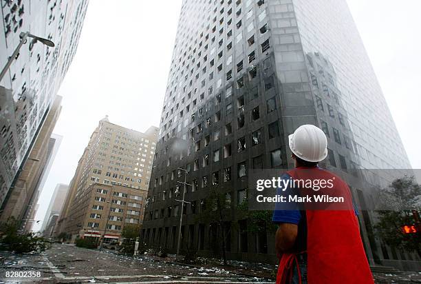 Man inspects the damage in front of the JP Morgan Chase Tower after Hurricane Ike past through the city September 13, 2008 in Houston Texas....