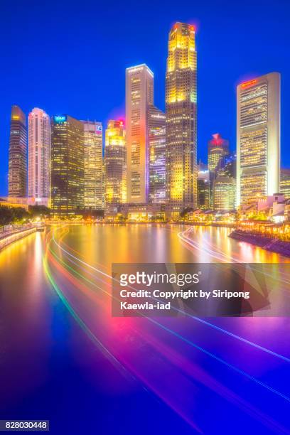 central business district view from boat quay with light trails in foreground, singapore. - singapore imagens e fotografias de stock