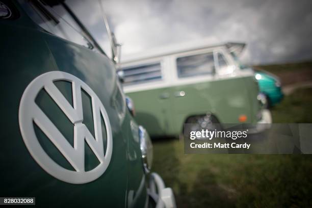 Classic Volkswagen campervan is parked on a cliff top as people gather on Fistral Beach in Newquay ahead of the annual Boardmasters festival on...