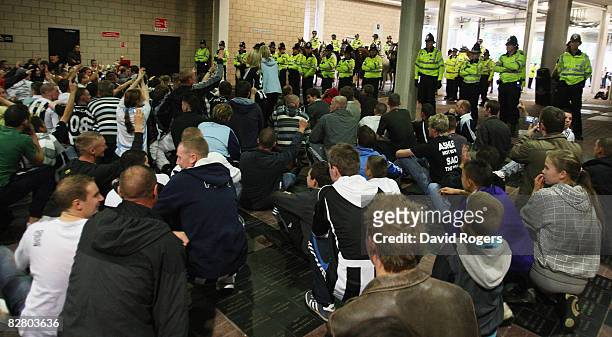 Newcastle United fans, protesting about the Newcastle board, perform a sit down protest and are confronted by police after their teams defeat in the...