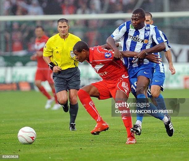 Valenciennes's forward Johan Audel vies with Grenoble's forward Franck Dja Djedje during their L1 football match on September 13, 2008 at the...
