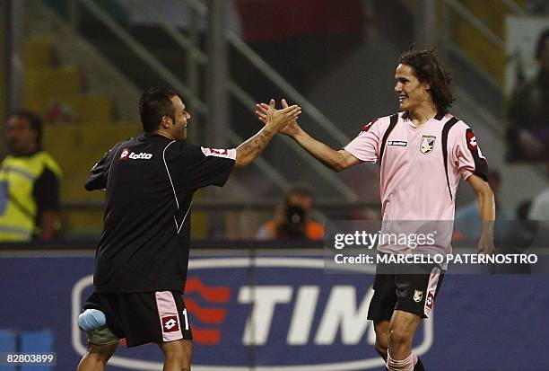 Palermo's forward Edinson Cavani of Uruguay celebrates after scoring the third goal for his team with teammate Fabrizio Miccoli, who scored the two...