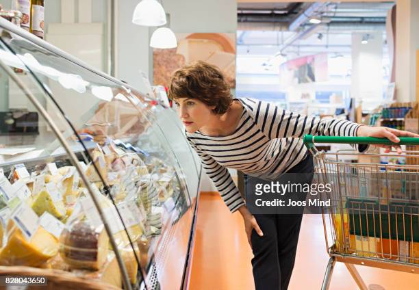 woman looking at cheese counter in supermarket - germany shopping bildbanksfoton och bilder