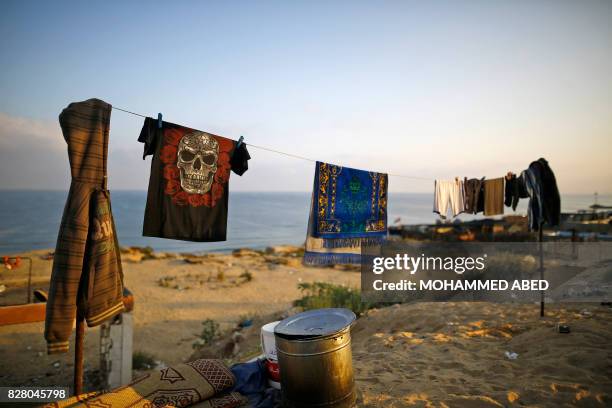 Clothes are seen hanging near a Hamas base targeted by Israeli warplanes in Gaza City on August 9, 2017. Three people were injured, including one...