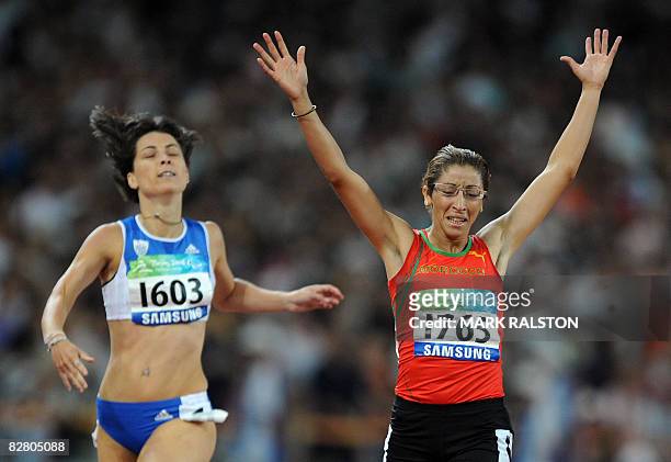 Sanaa Benhama of Morocco celebrates as she beats Alexandra Dimoglou of Greece in the final of the women's 400 metre T13 classification event at the...