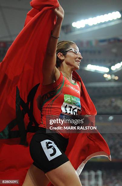 Sanaa Benhama of Morocco celebrates after winning the final of the women's 400 metre T13 classification event at the 2008 Beijing Paralympic Games in...