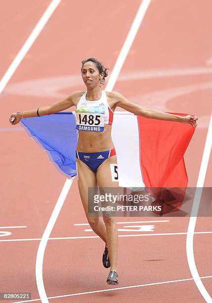 Partially-sighted runner Assia El'Hannouni of France celebrates winning gold in the women's 400m T12 final event during the 2008 Beijing Paralympic...