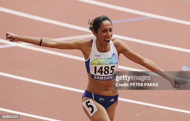 Partially sighted runner Assia El'Hannouni of France celebrates winning gold in the women's 400m T12 final event during the 2008 Beijing Paralympic...