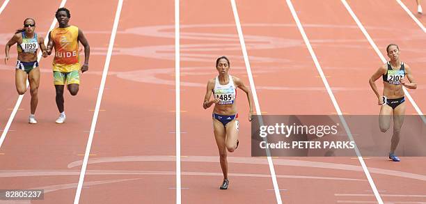 Partially-sighted runner Assia El'Hannouni of France wins gold in the women's 400m T12 final event over Oxana Boturchuk of Ukraine and Terezinha...