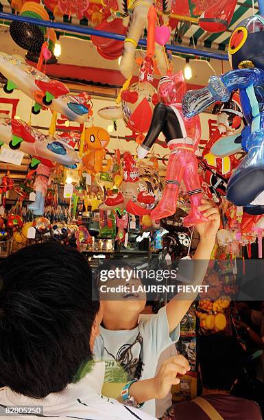 Father and son choose a lantern to celebrate the Mid-Autumn Festival in Hong Kong on September 13, 2008. The Mid-Autumn Festival, also known as the...