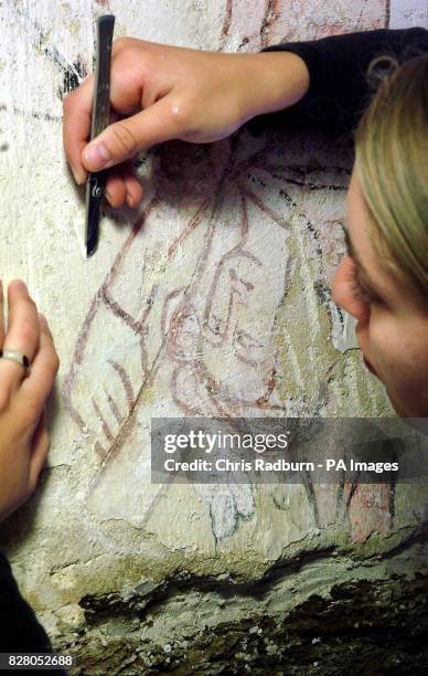 Juliane Kownatzki, works on a 14th century wall painting, showing a fallen king, part of an overall painting depicting a wheel of fortune, discovered...