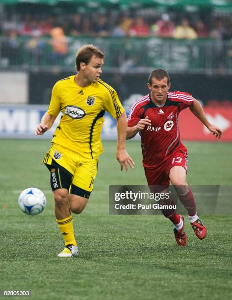 Forward Chad Barrett of Toronto FC chases defender Chad Marshall of the Columbus Crew during their match on September 13, 2008 at BMO Field in...