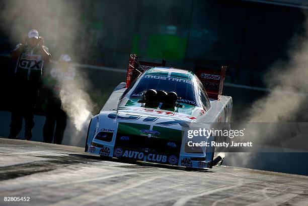 Ashley Force, driver of the Castrol GTX funny car does a burn out during qualifying for the NHRA Carolinas Nationals at the Zmax Dragway on September...