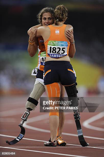 Annette Roozen and Marije Smits of the Netherlands celebrate after the women's 100m T42 final during the 2008 Beijing Paralympic Games at the...