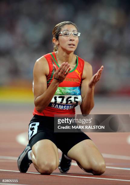 Sanaa Benhama of Morocco prays after winning the final of the women's 200 metre T13 classification event at the 2008 Beijing Paralympic Games in...