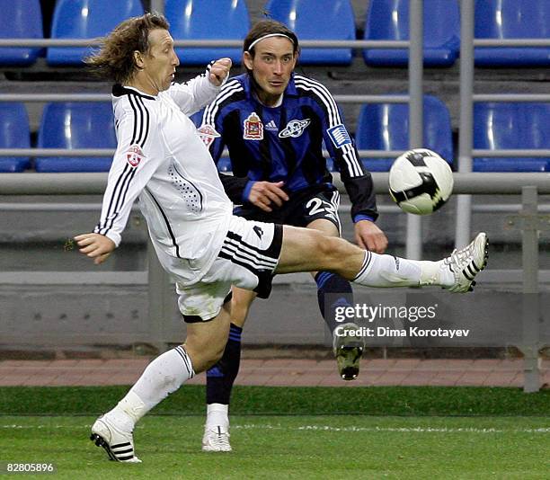 Igor Lebedenko of FC Saturn Moscow Region competes for the ball with Vasili Yanotovsky of FC Tom Tomsk during the Russian Football League...