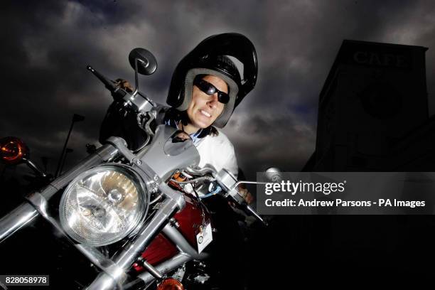 Kathryn Evans from Wigan starts her engine as she joins 14 other women bikers at the Ace Caf in north London Saturday August 20 2005, before they set...