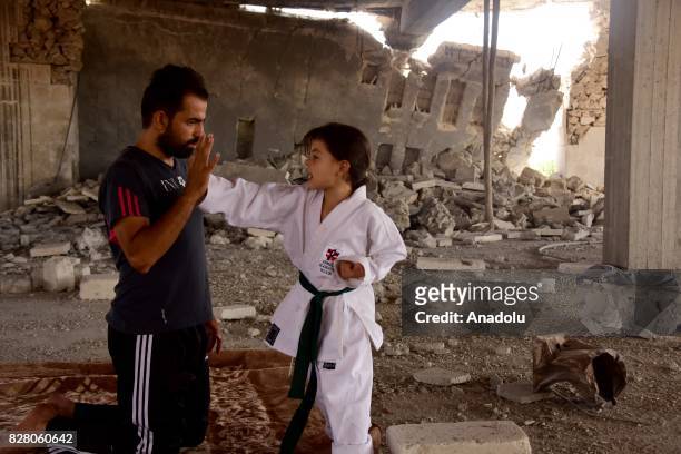 Year-old Syrian girl, Nur Setut, born in 2011 when Syrian civil war began, exercises karate with her father in Aleppo, Syria on August 09, 2017....