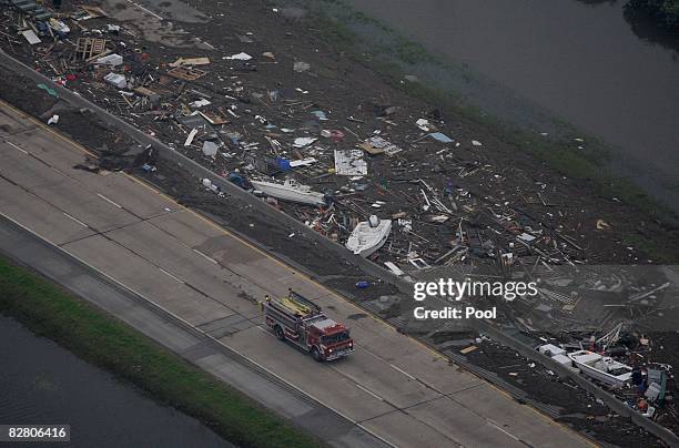 In this aerial photo, a fire truck drives by debris along Interstate 45 after Hurricane Ike made landfall September 13, 2008 in Galveston, Texas. Ike...