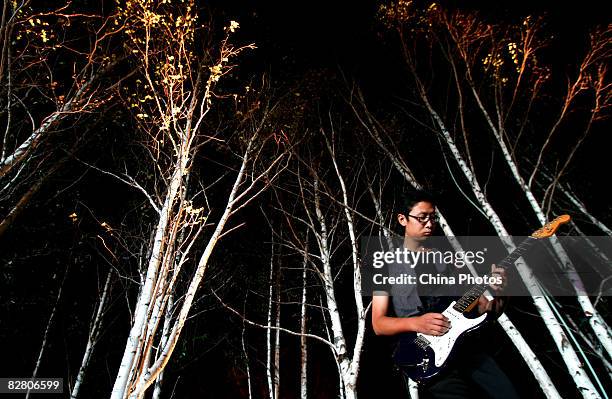 Guitar player performs during an evening to mark the Mid-Autumn Festival on September 13, 2008 in Xian of Shaanxi Province, China. The Mid-Autumn...