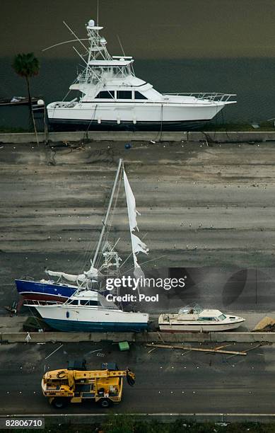 In this aerial photo, boats sit on the roadway as heavy equipment moves in to clear debris on Interstate 45 headed toward Galveston Island after the...