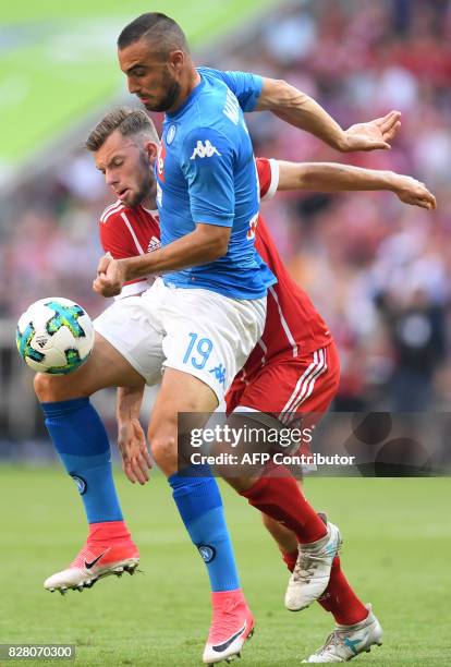 Napoli's striker Leonardo Pavoletti and Bayern Munich's midfielder Manuel Wintzheimer vie for the ball during the third place Audi Cup football match...